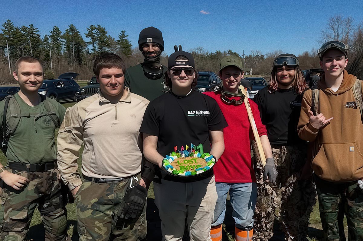 A parent and child playing airsoft together
